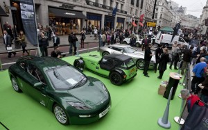 Regent Street Motor Show, a Delta Electric Car in the foreground sits quietly beside a Caterham and Aston Martin